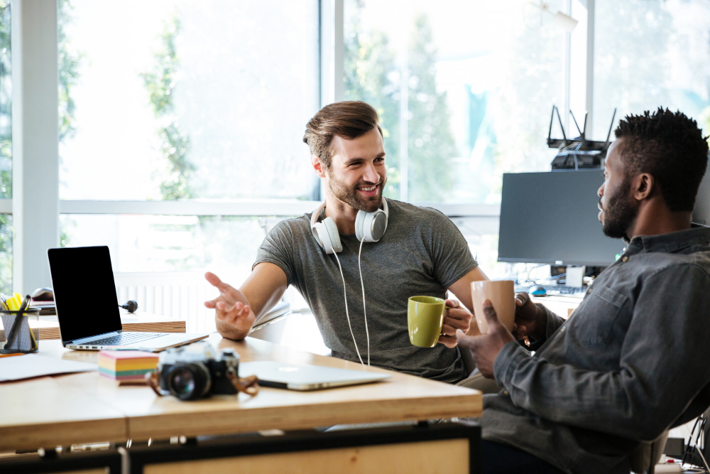 young men drinking coffee at the office